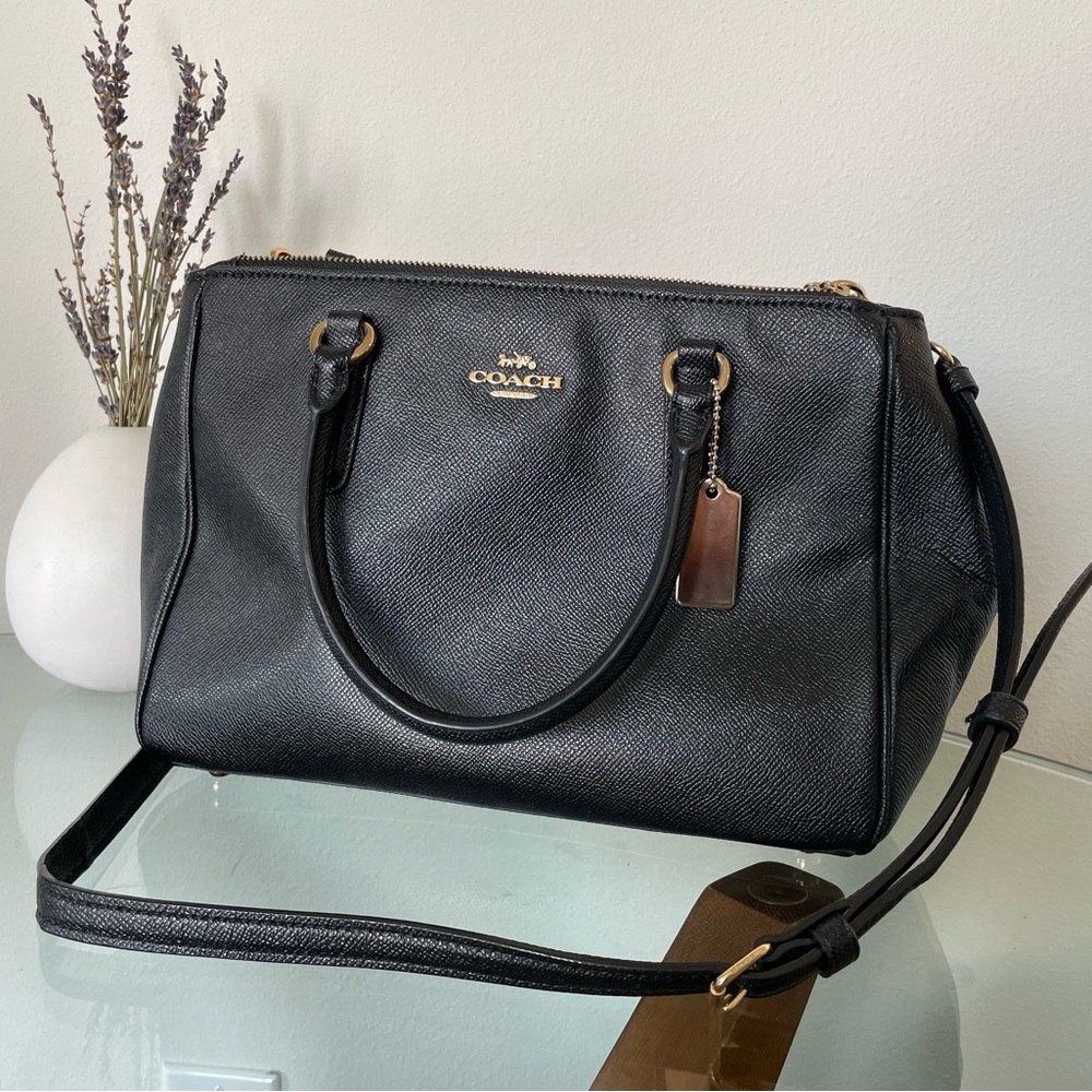 Coach purse, black with golden accents.